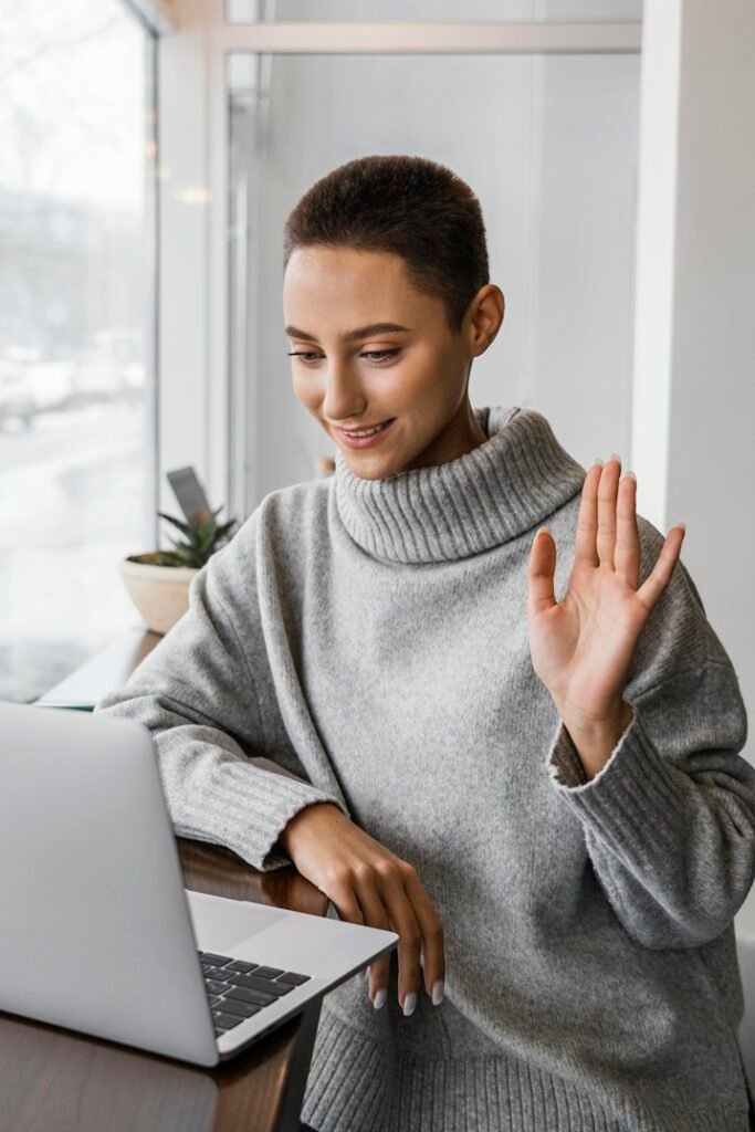 medium shot woman waving laptop